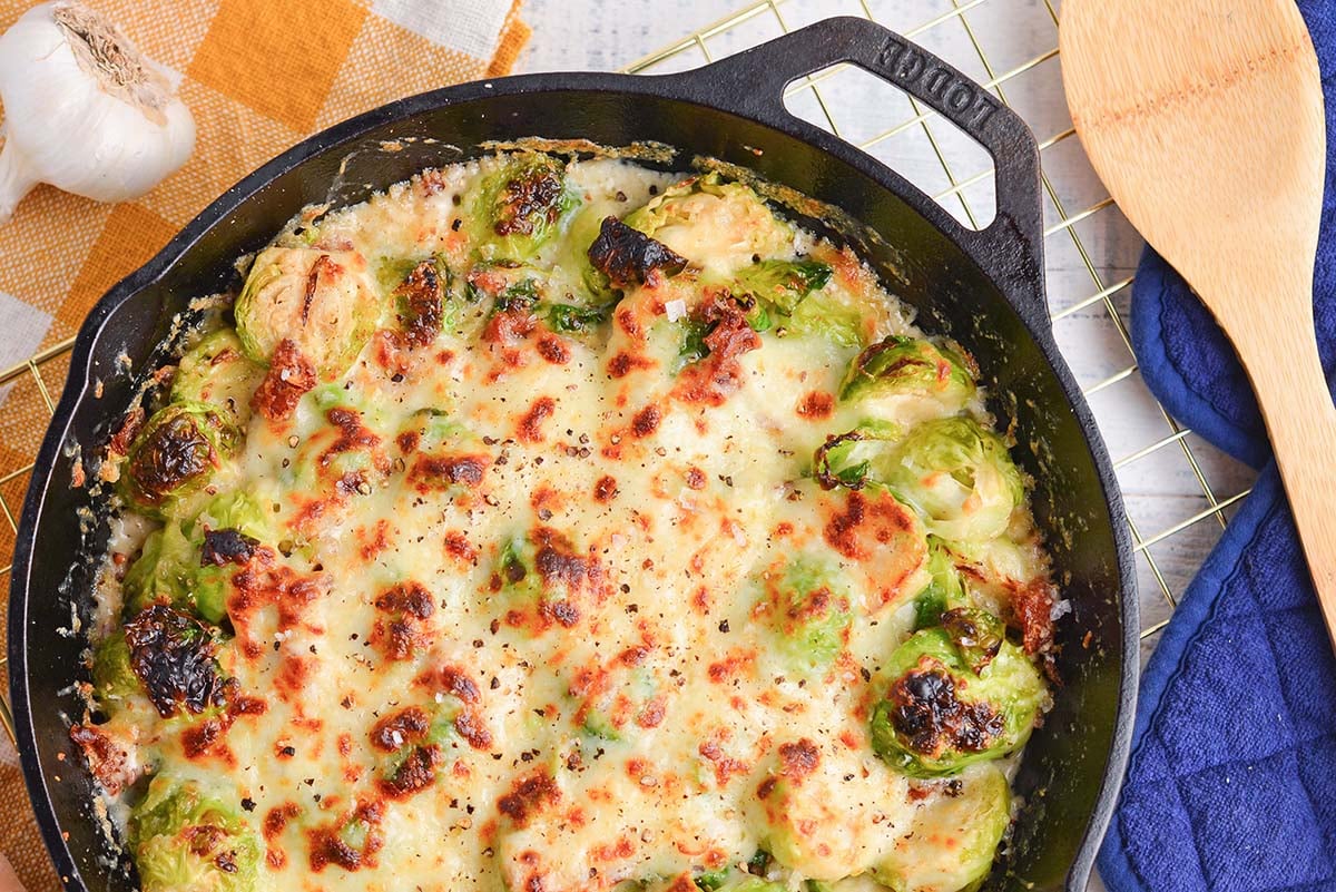 close up overhead shot of brussels sprouts au gratin in pan