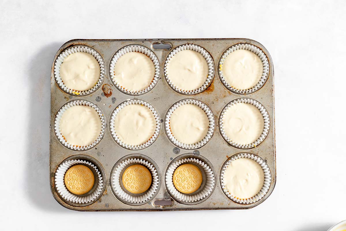 white layer of cheesecake in mini cheesecake muffins