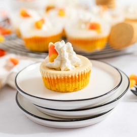 mini halloween cheesecakes on a pile of 3 plates