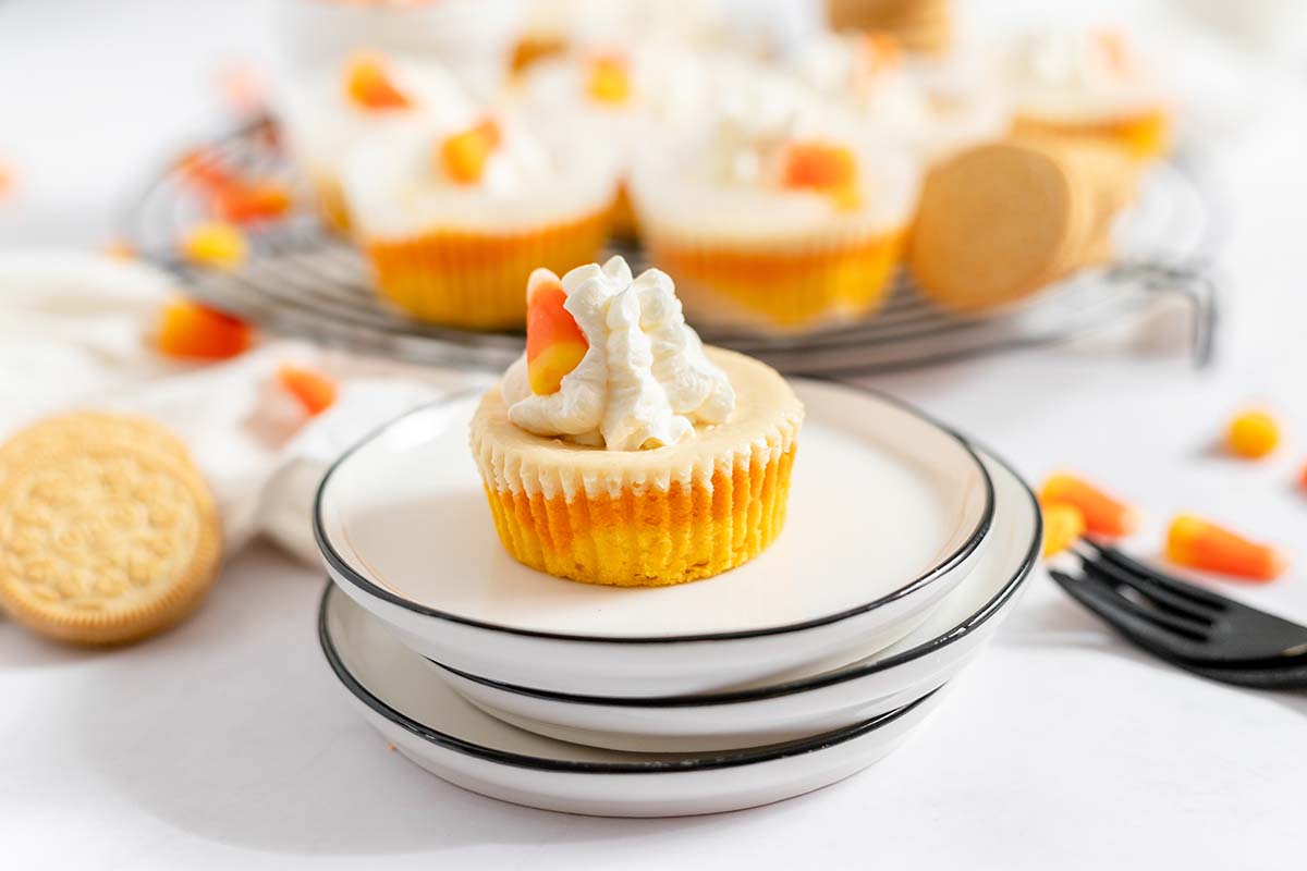 mini halloween cheesecakes on a pile of 3 plates