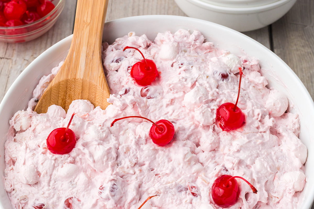 close up angled shot of wooden spoon in bowl of classic cherry fluff