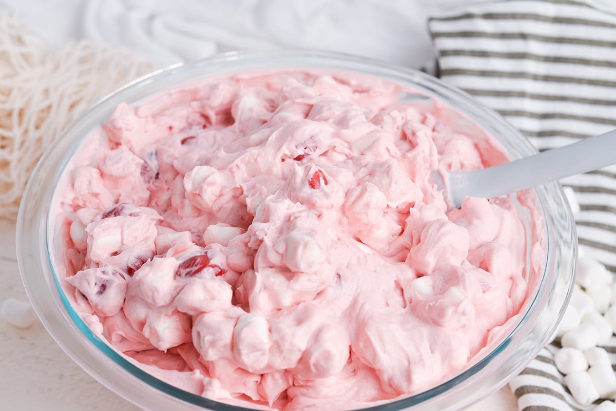 angled shot of rubber spatula in bowl of cherry fluff