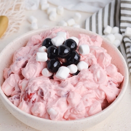 angled shot of cherry fluff topped with marshmallows and cherries