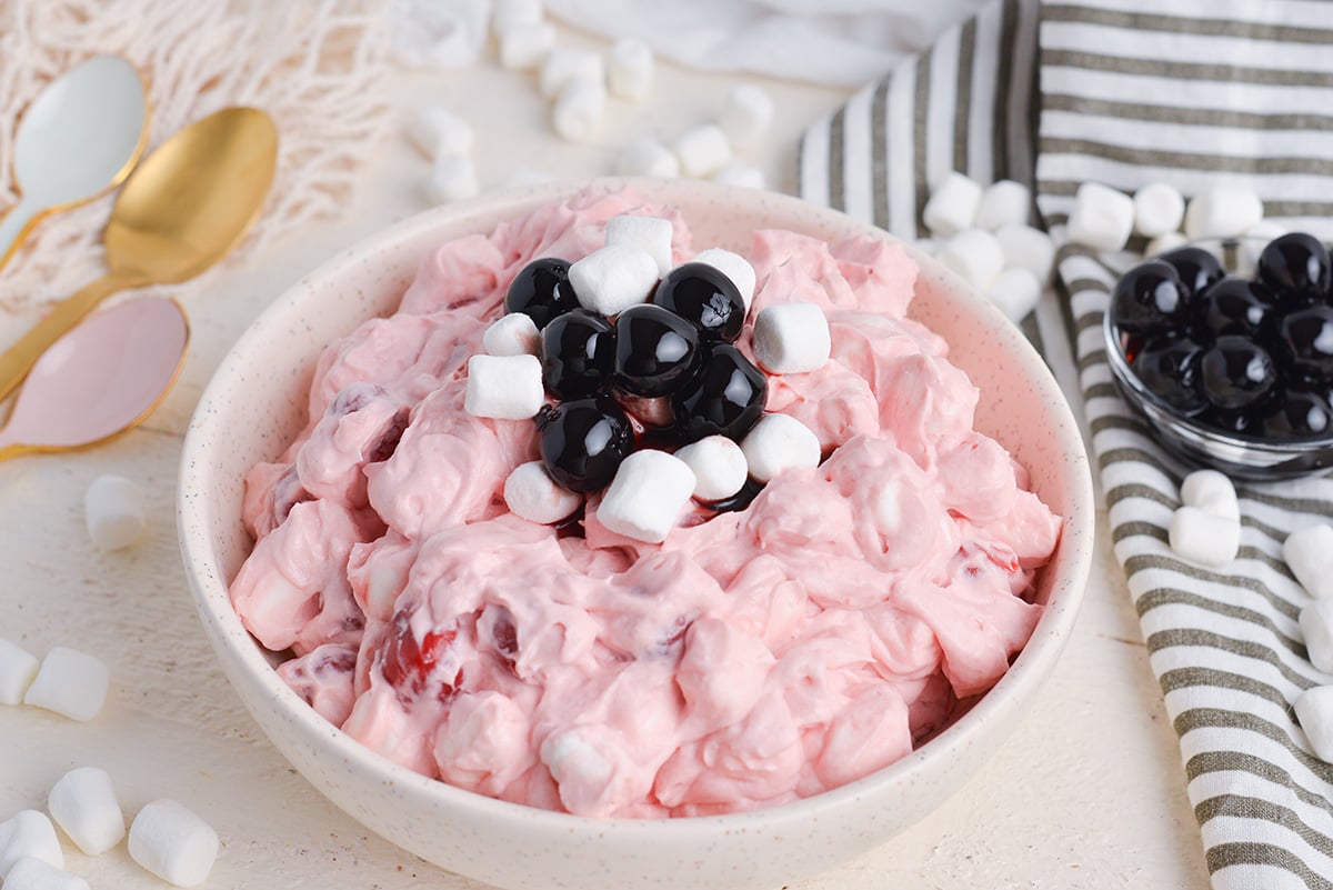 angled shot of cherry fluff topped with marshmallows and cherries