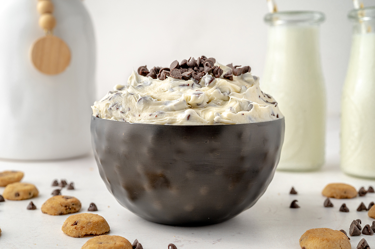 black bowl of chocolate chip cookie dough dip with chocolate chips