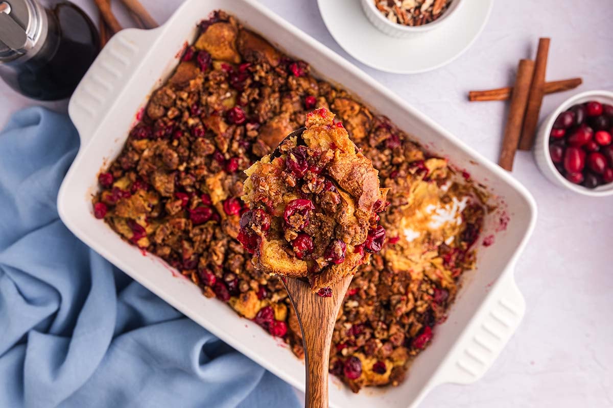 overhead shot of wooden spoon full of cranberry french toast casserole