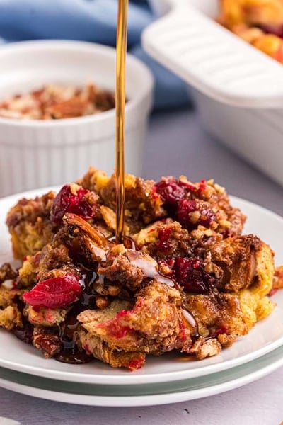 angled shot of syrup pouring on french toast casserole on plate