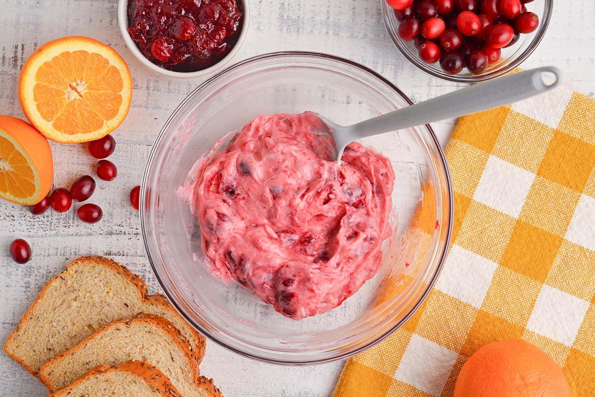 mixing cranberry mayo in a glass mixing bowl