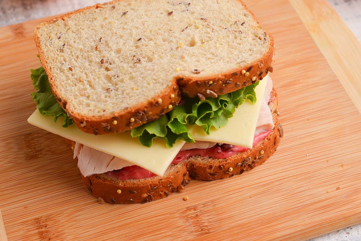 turkey sandwich with cranberry mayo on seeded bread