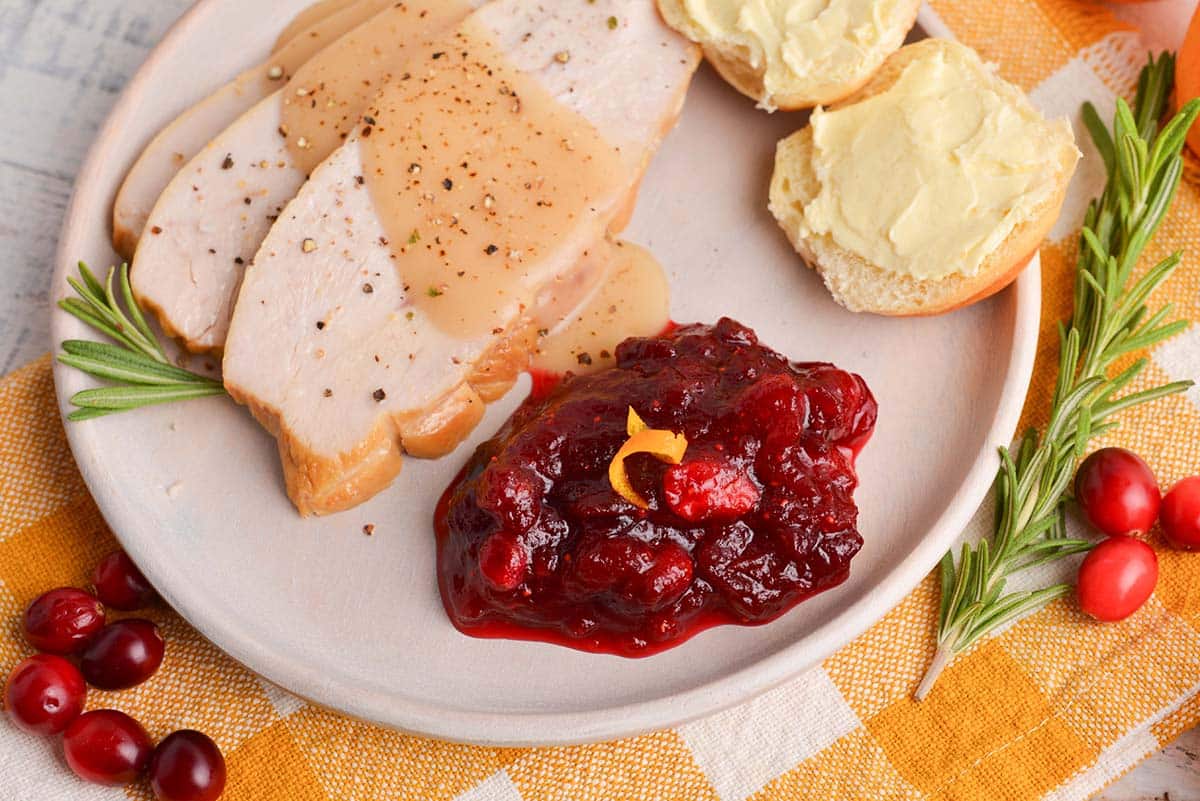 overhead of cranberry relish on a plate with roast turkey breast