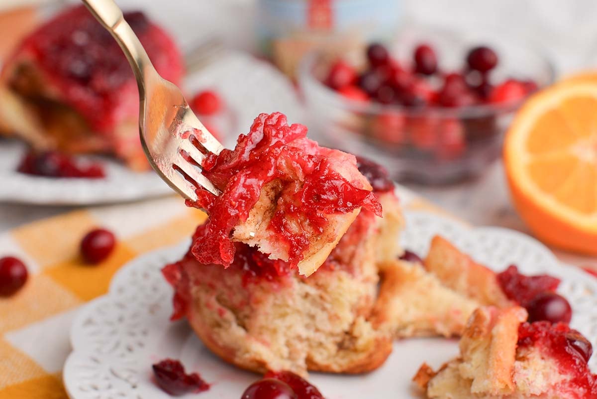 close up of bite of cranberry cinnamon roll on fork