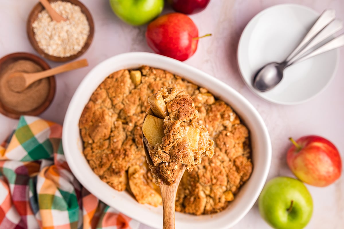 overhead shot of wooden spoon full of apple crisp