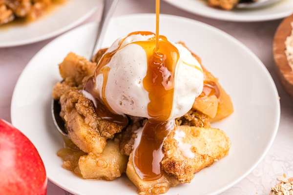 close up of caramel drizzled onto apple crisp