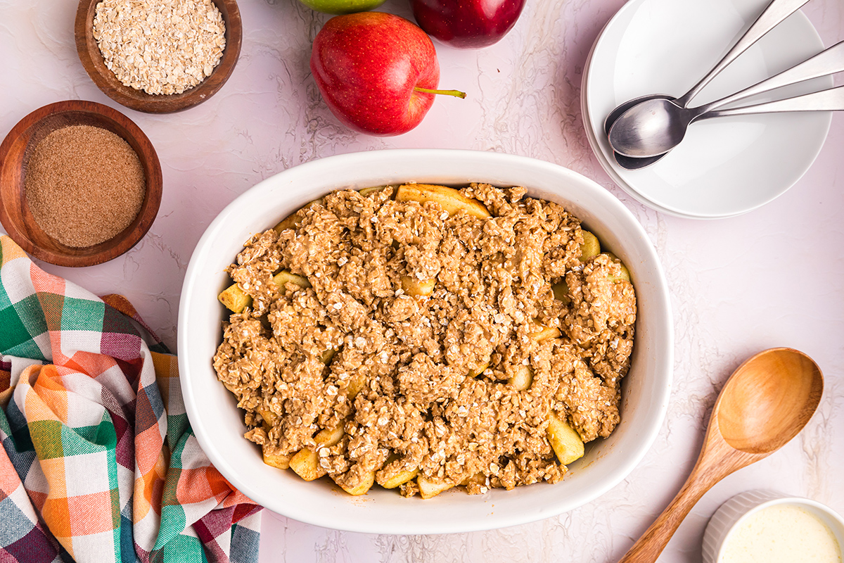 apples topped with oat topping in baking dish