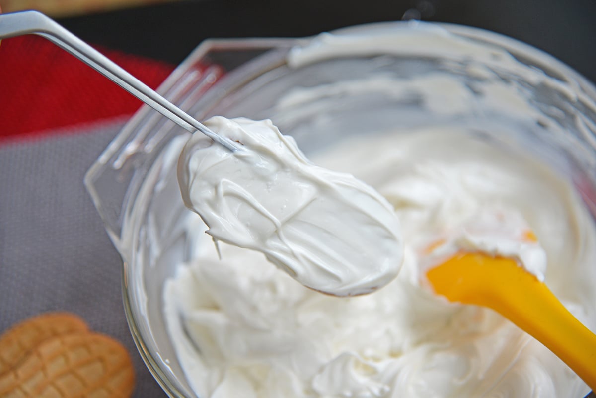 nutter butter dipping into white chocolate