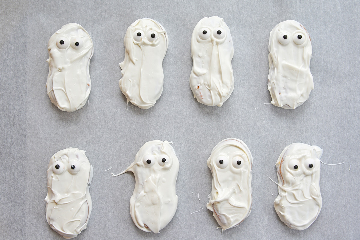 overhead shot of ghost cookies on parchment paper