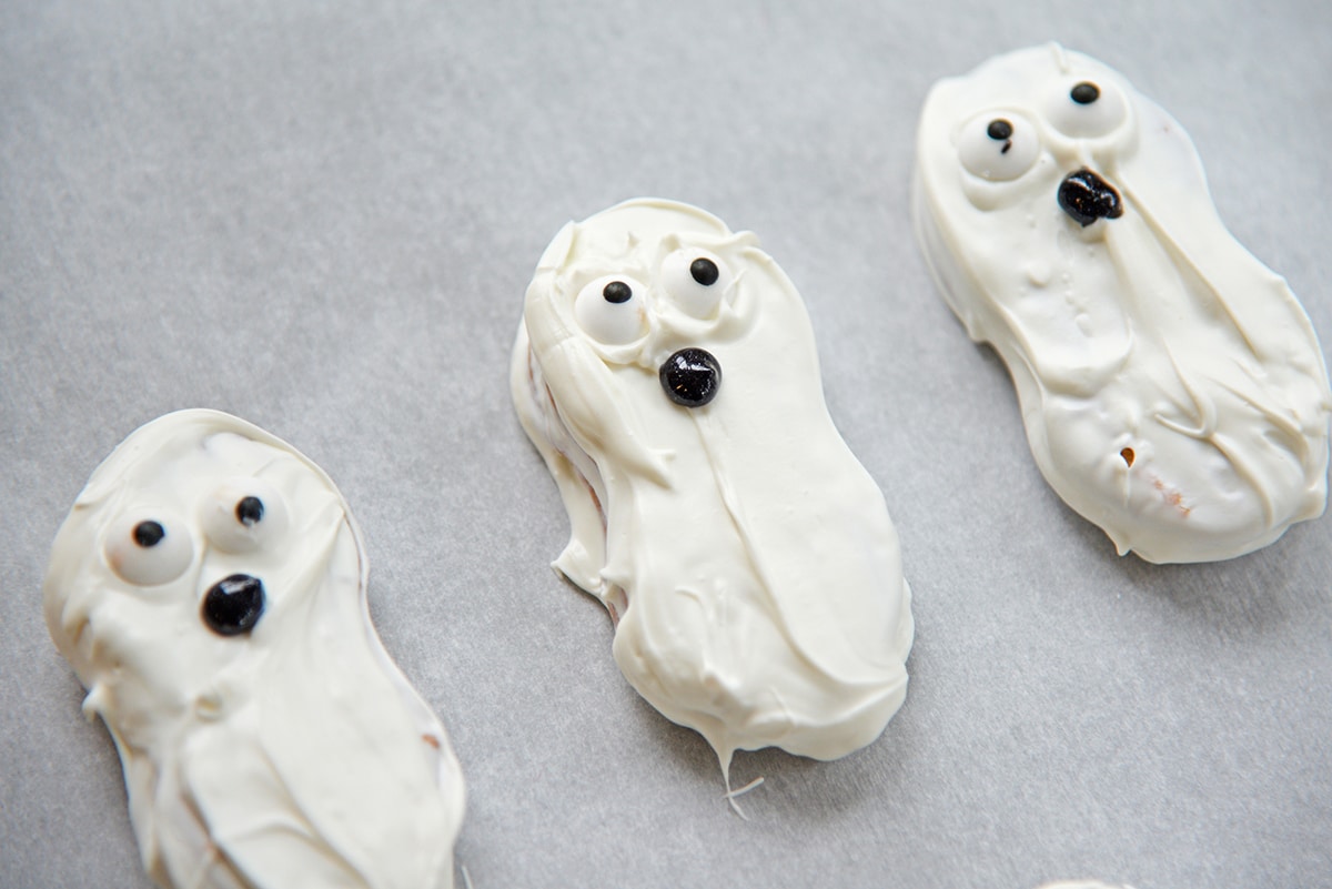 ghost cookies on parchment paper