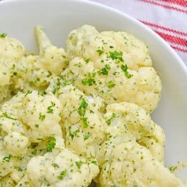 close up of cauliflower with green curry sauce