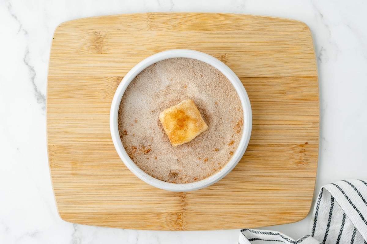 marshmallow in bowl of cinnamon sugar