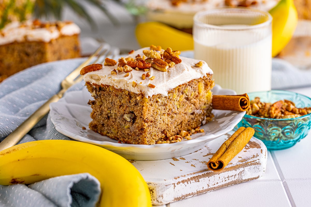 close up slice of cake with pecans on top