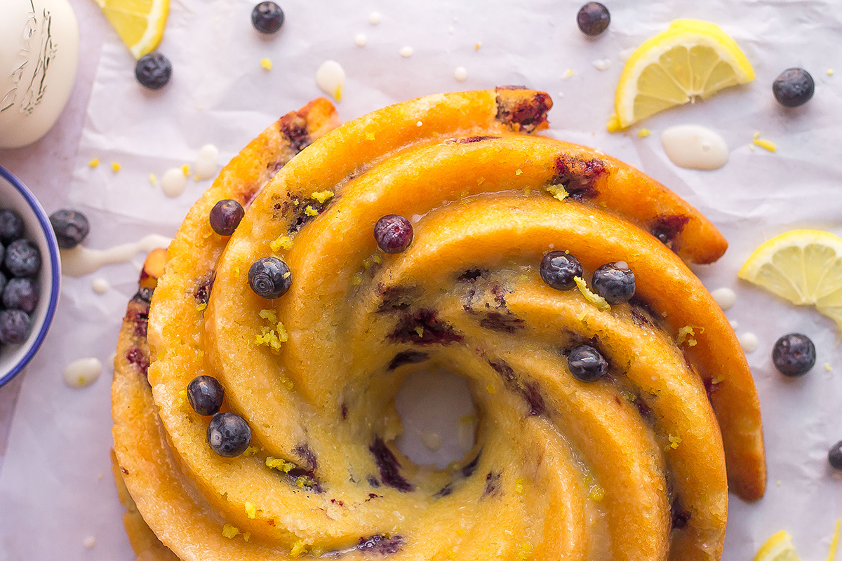 close up of swirl bundt cake from overhead with lemons and blueberries