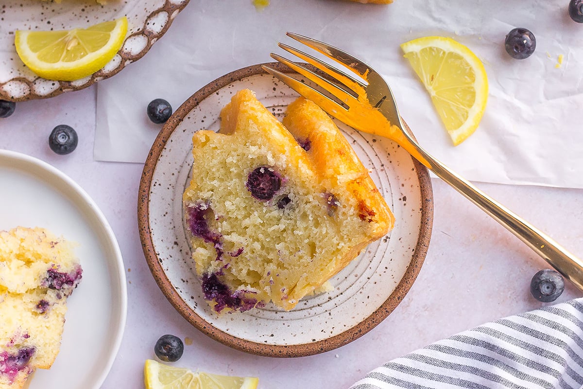 overhead slice of cake with blueberries and lemon
