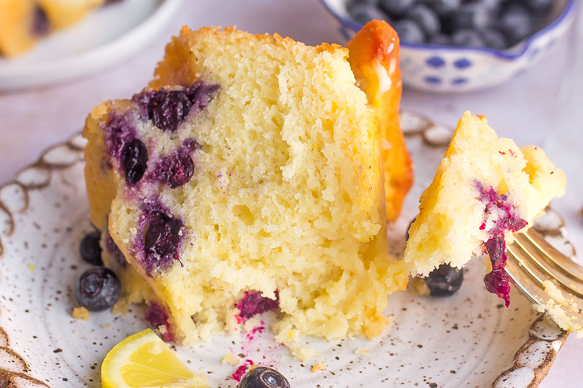 close up of a slice of blueberry lemon cake