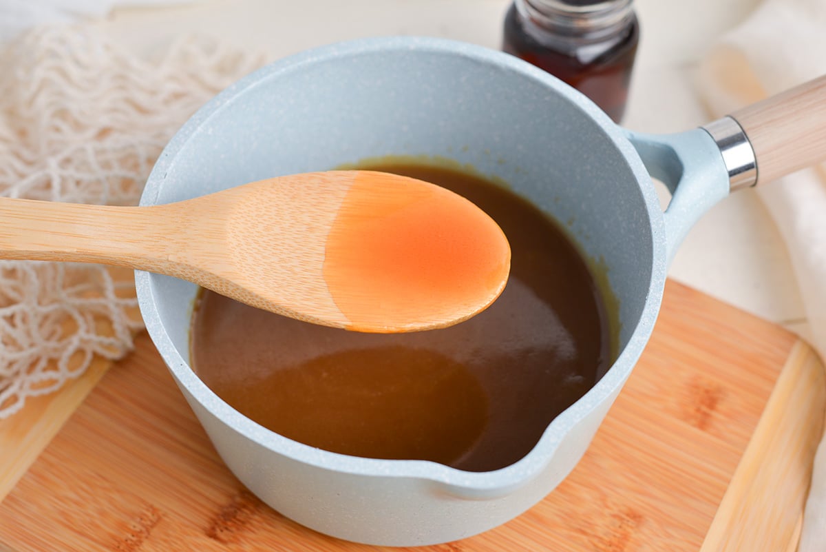 wooden spoon in pot of maple cream sauce