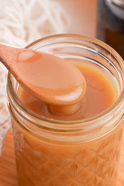 angled shot of spoon in jar of sauce