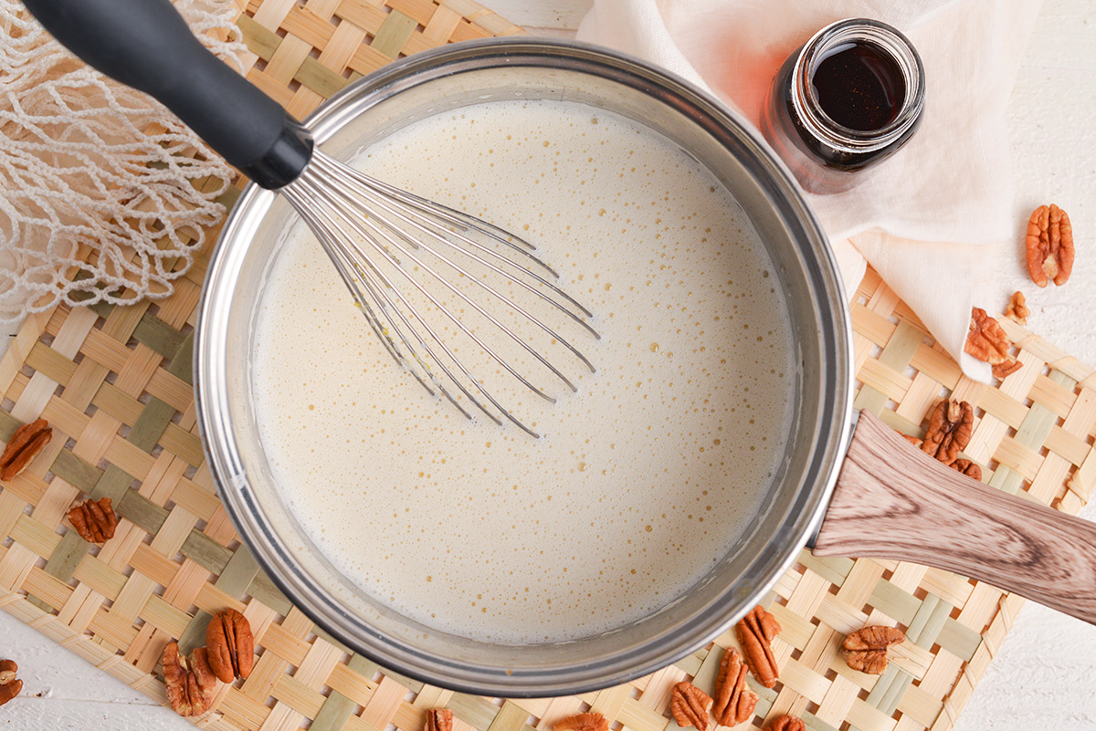 overhead shot of custard in pan with whisk