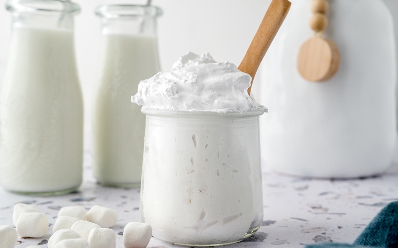 glass jar of fluff with a wooden spoon