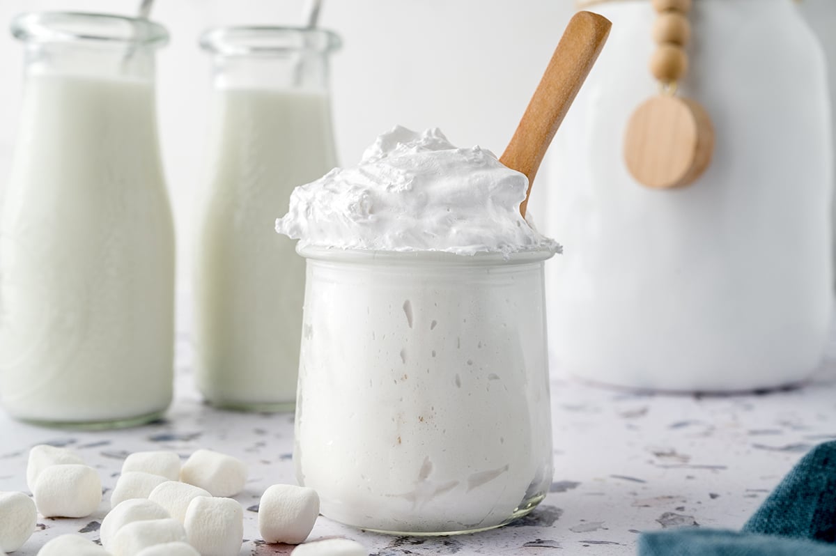 glass jar of fluff with a wooden spoon