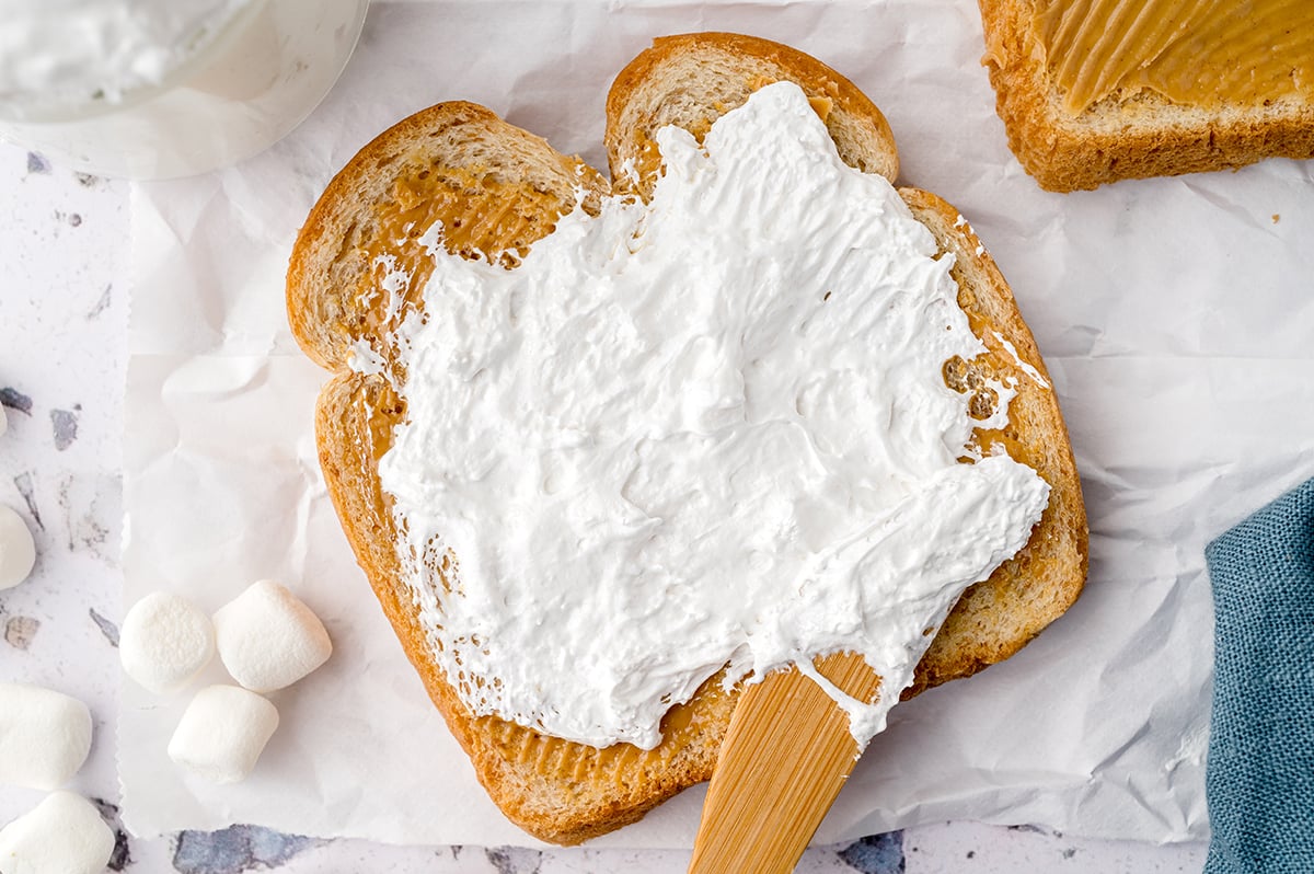 spreading fluff in a peanut butter toast