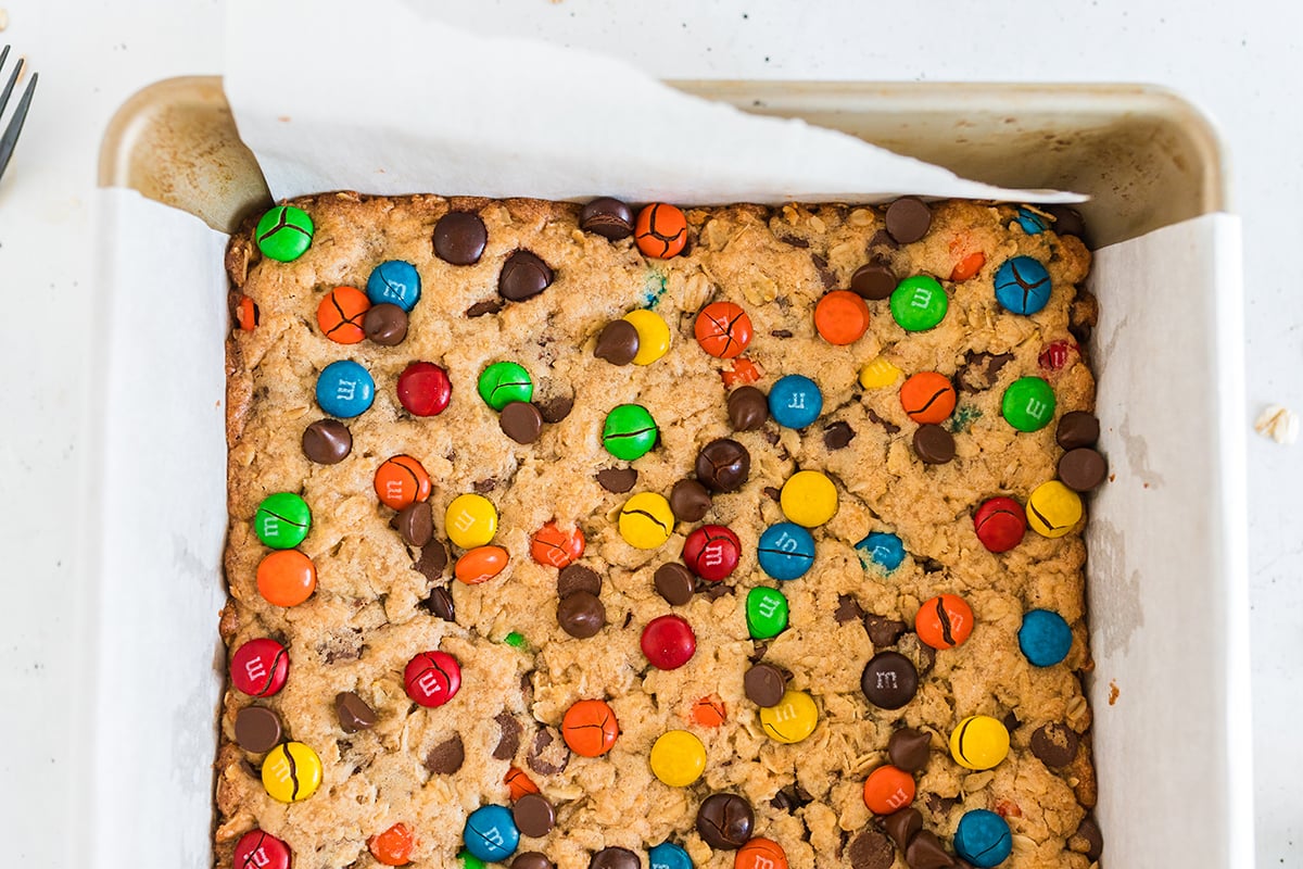close up overhead shot of baked monster cookie bars in pan