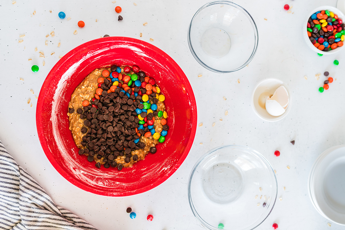 m&ms and chocolate chips in oat dough