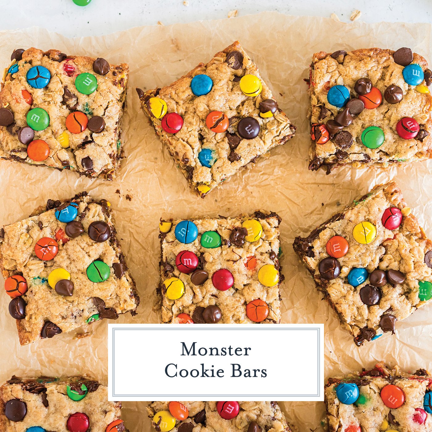 overhead shot of monster cookie bars on parchment paper with text overlay for facebook