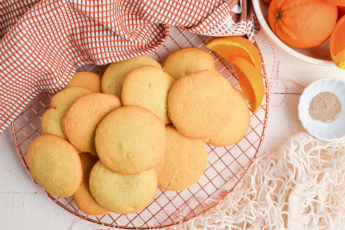 overhead image of orange cardamom cookies on a wire cooling rack