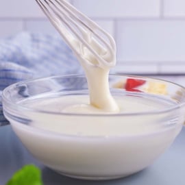 whisk drizzling mixed icing into a bowl