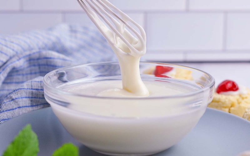 whisk drizzling mixed icing into a bowl