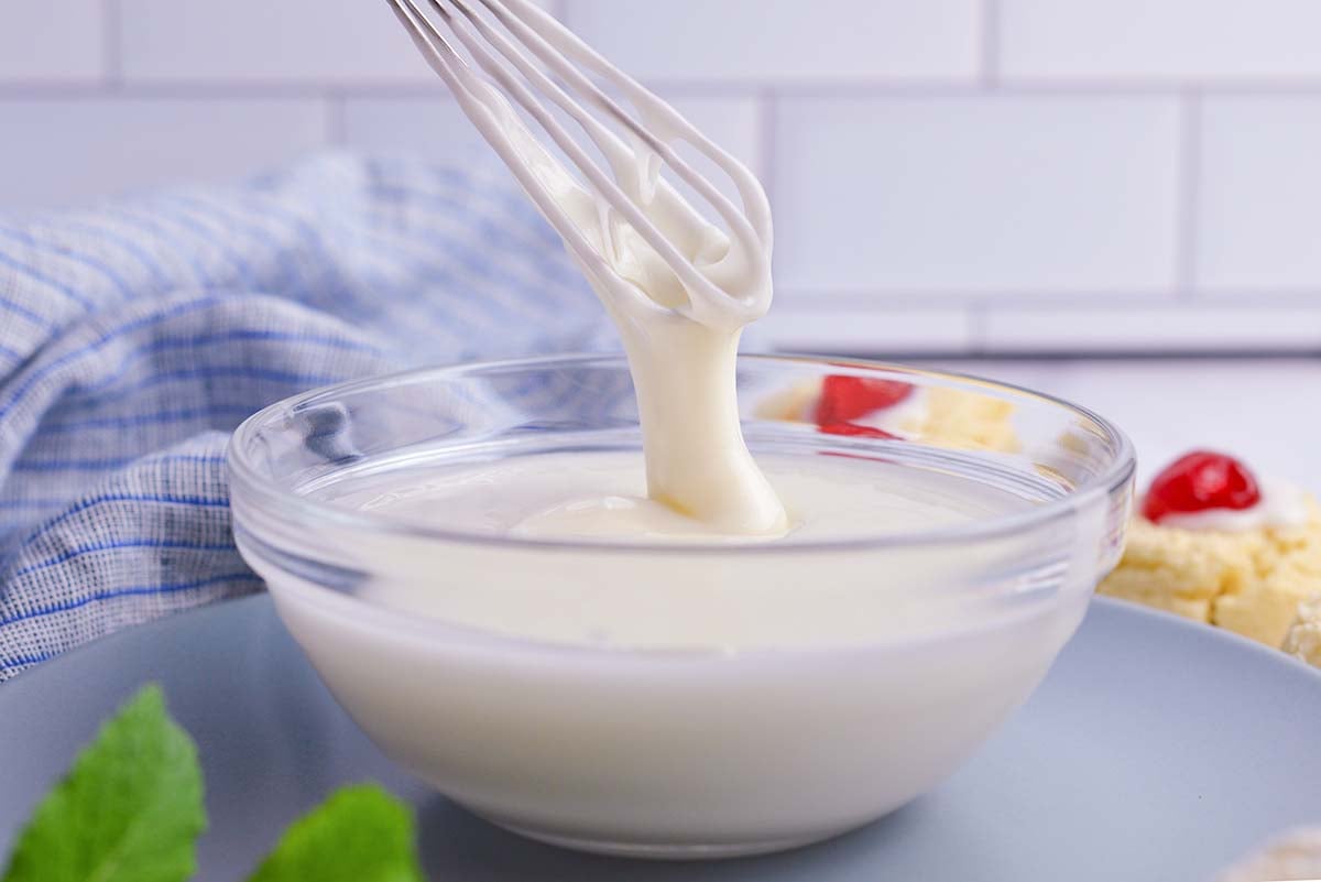 whisk drizzling mixed icing into a bowl