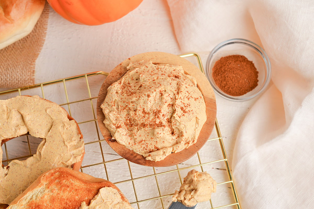 overhead shot of pumpkin cream cheese in wooden bowl