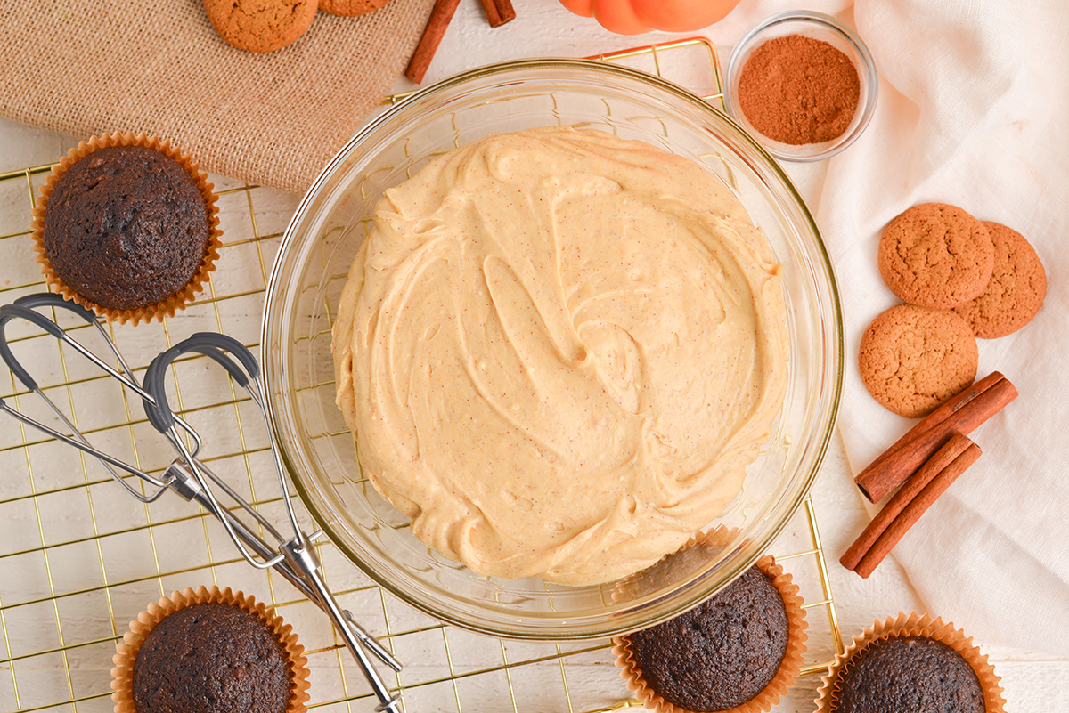 overhead shot of pumpkin cream cheese frosting in mixing bowl