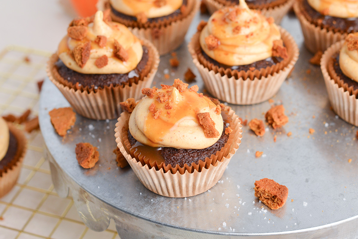 angled shot of chocolate cupcakes topped with cookie crumbles