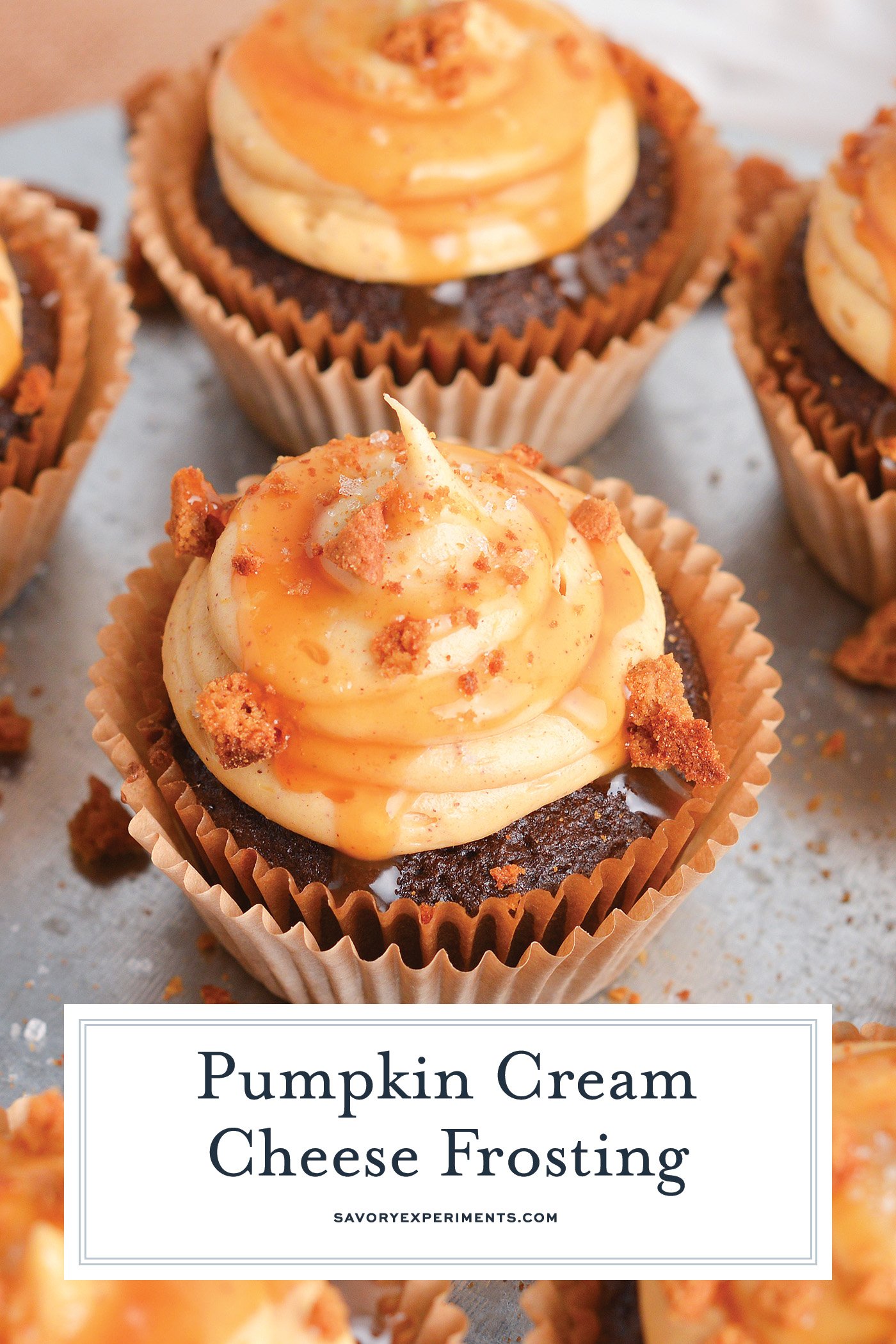 angled shot of chocolate cupcakes topped with pumpkin cream cheese frosting with text overlay for pinterest