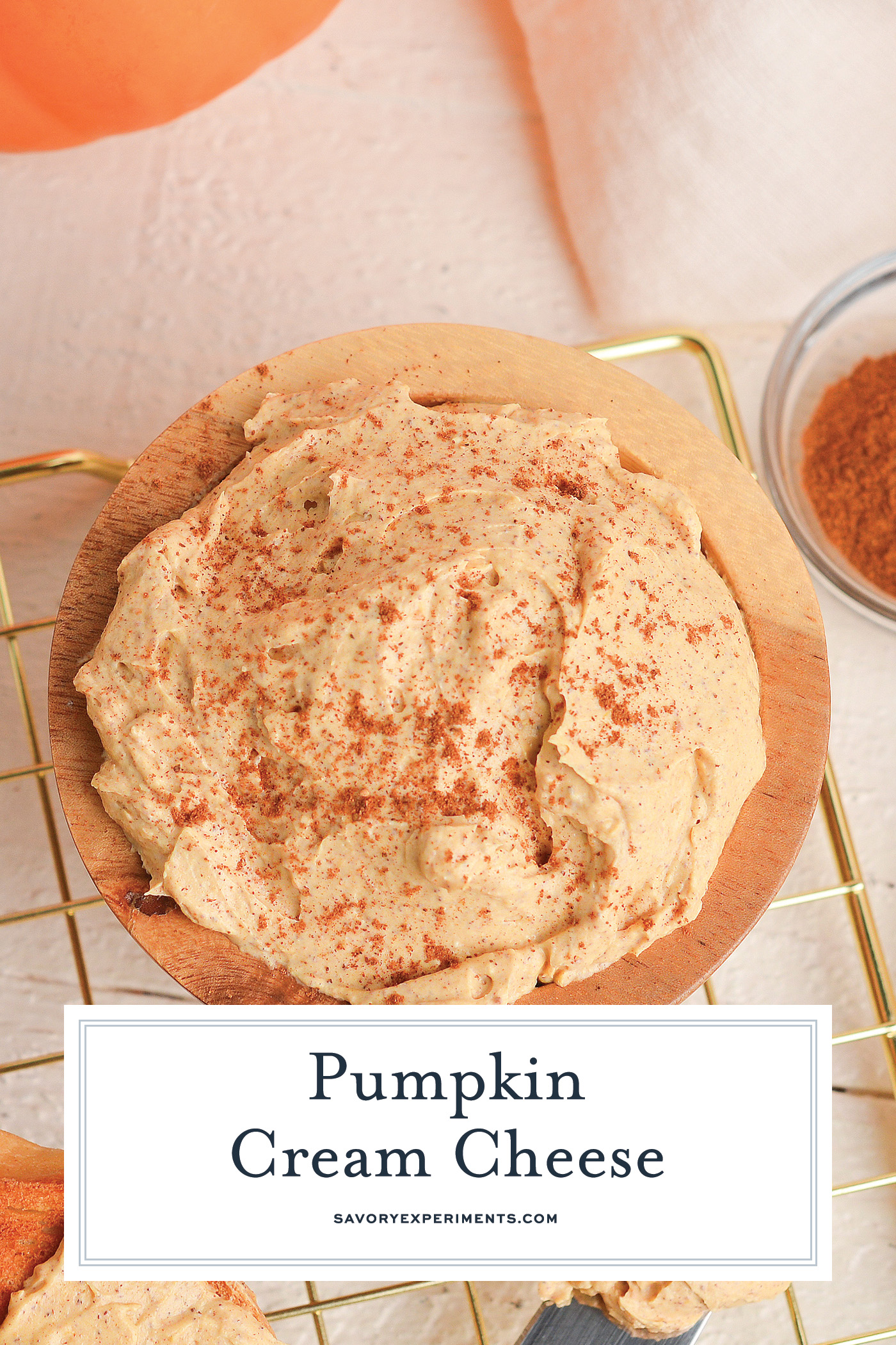 overhead shot of pumpkin cream cheese in wooden bowl with text overlay for pinterest