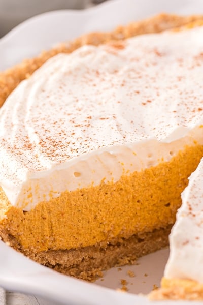 angled shot of slice taken out of pumpkin mousse pie