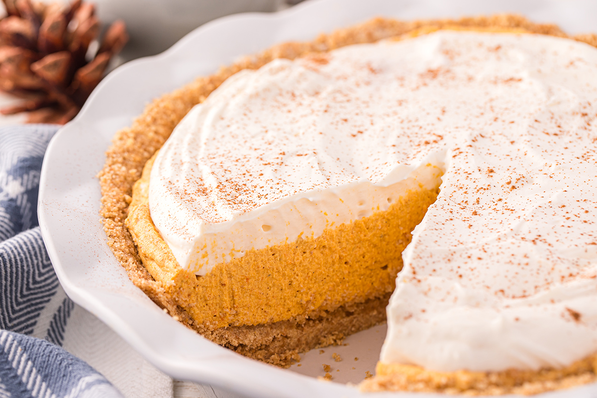 angled shot of slice taken out of pumpkin mousse pie