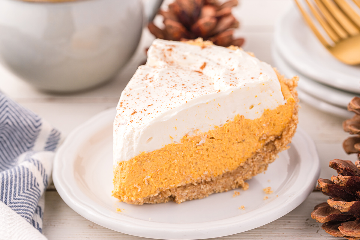 angled shot of slice of pumpkin mousse pie on plate