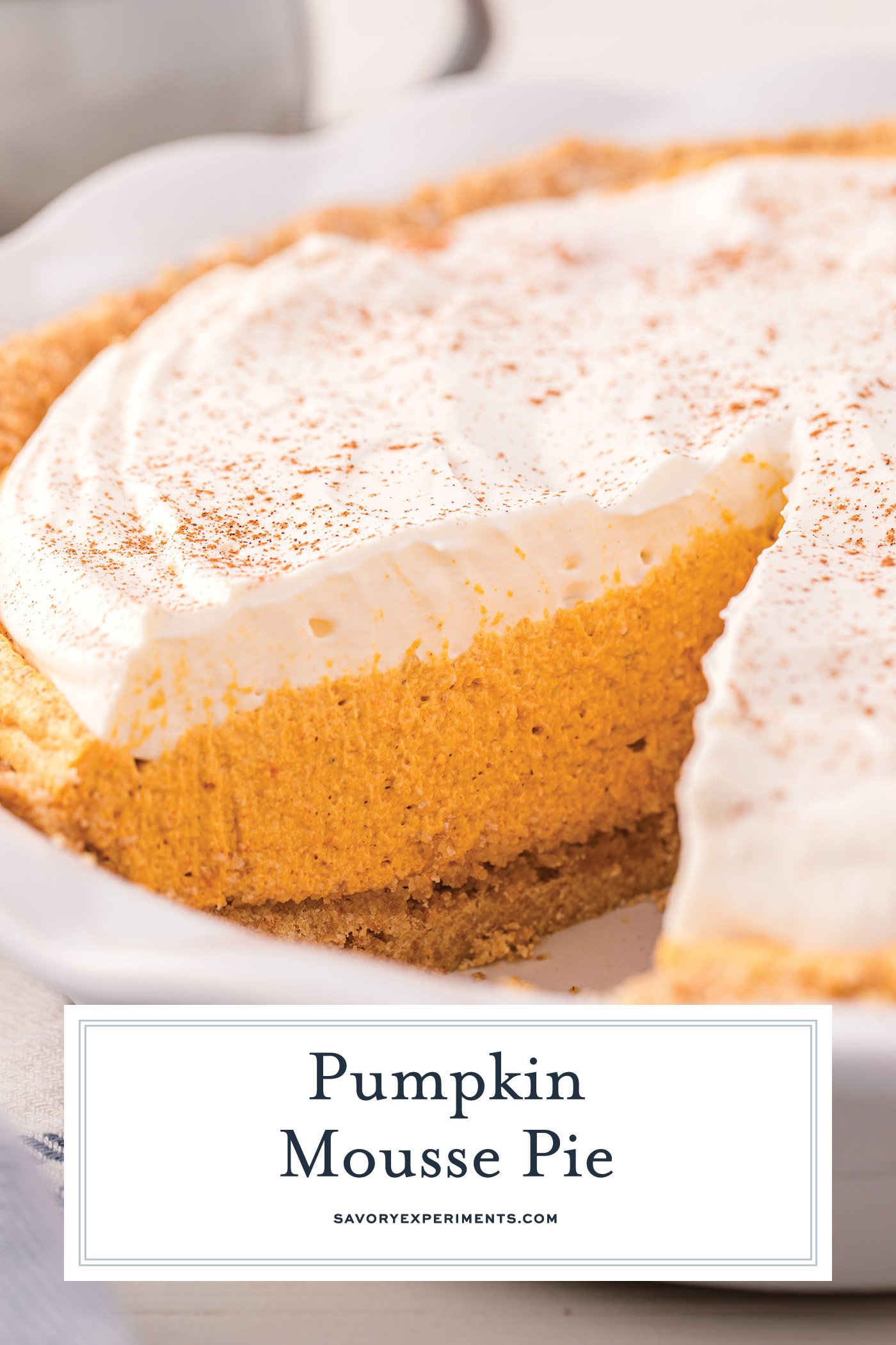 close up angled shot of slice taken out of pumpkin mousse pie with text overlay for pinterest