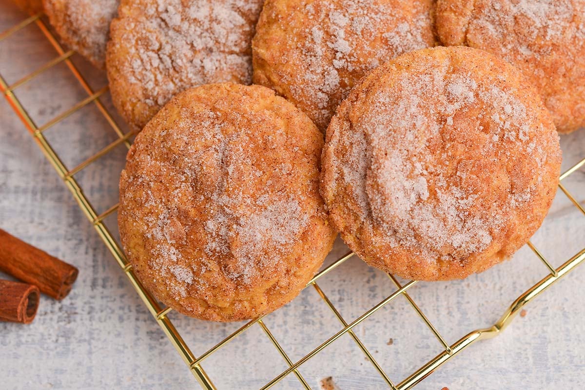 close up overhead shot of pile of pumpkin snickerdoodles on cooling rack